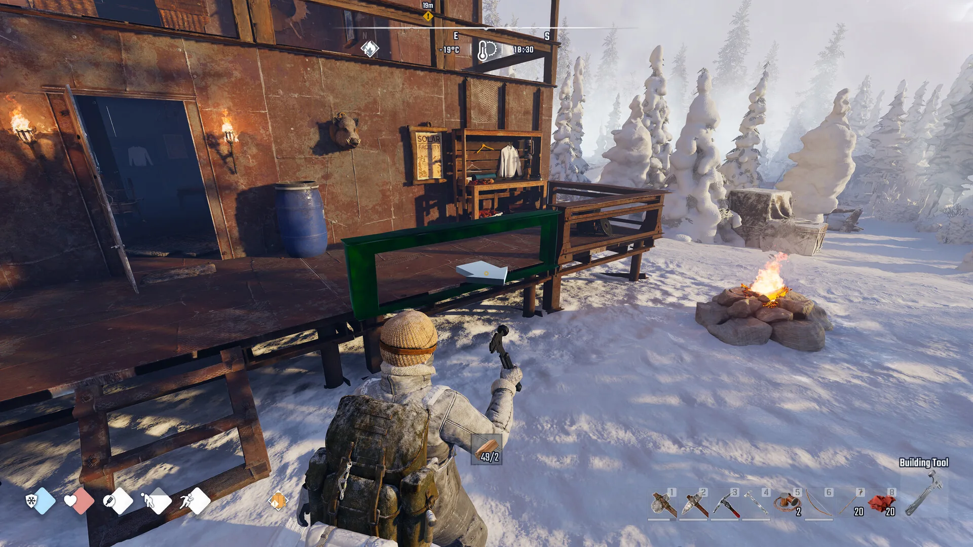 A Permafrost player building out a restored shelter in the snow