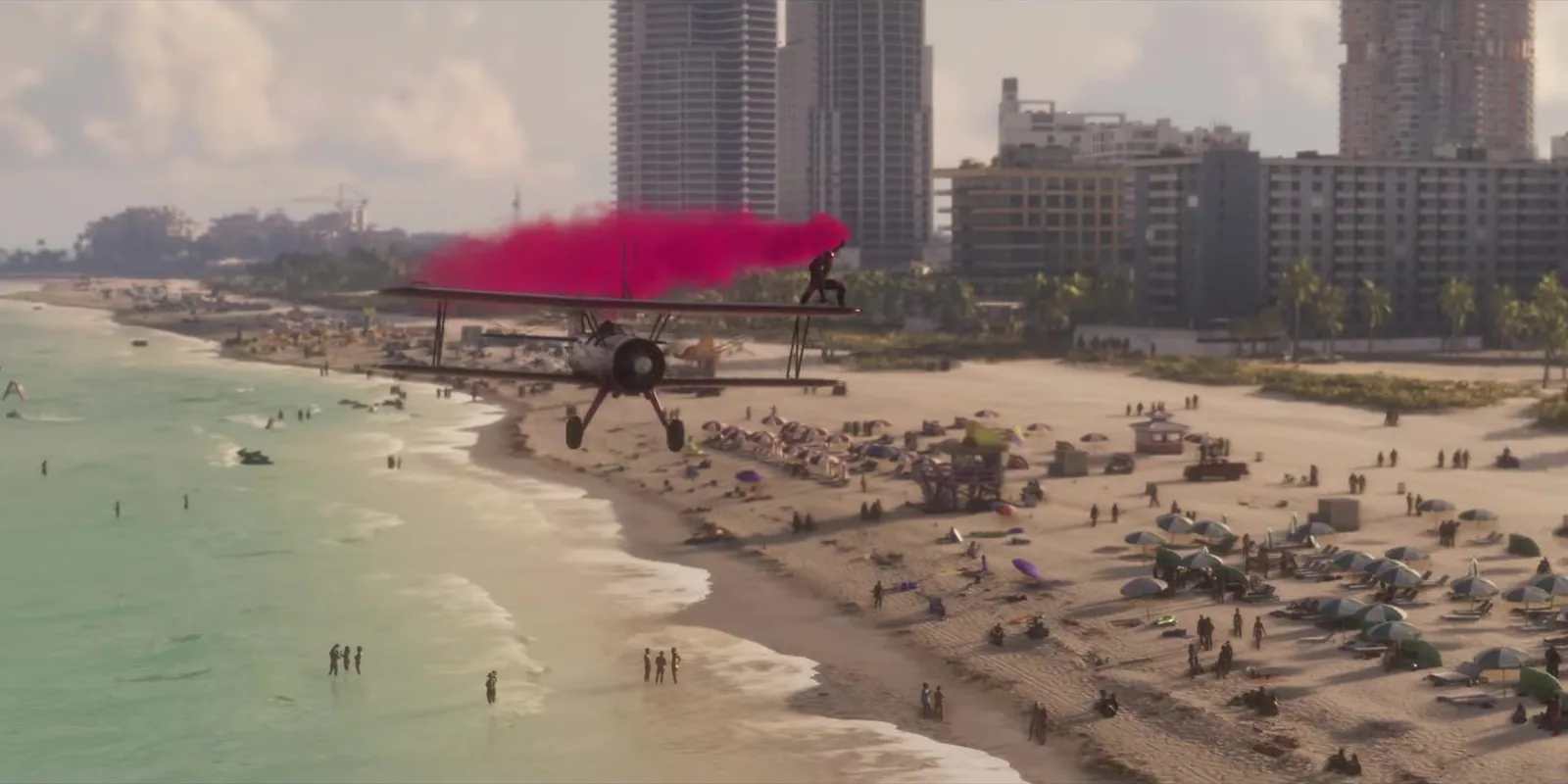 A biplane trailing pink smoke over a crowded beach in the GTA 6 launch trailer